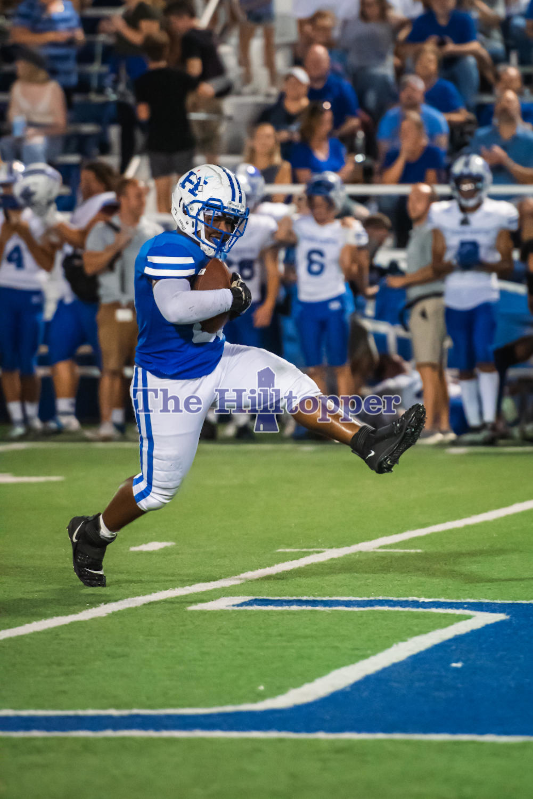 Senior-Trevaughn-Woods-high-steps-with-the-ball-after-recovering-Simon-Kenton_s-fumble.png