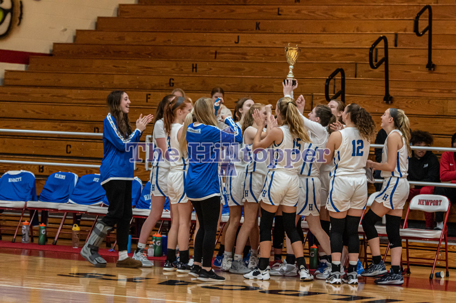 The-Varsity-Girls-Basketball-team-huddles-with-there-trophy-after-winning-the-championship-game-vs.-Augusta-at-the-Donna-Murphy-Showcase.-jenna-richey-2.png